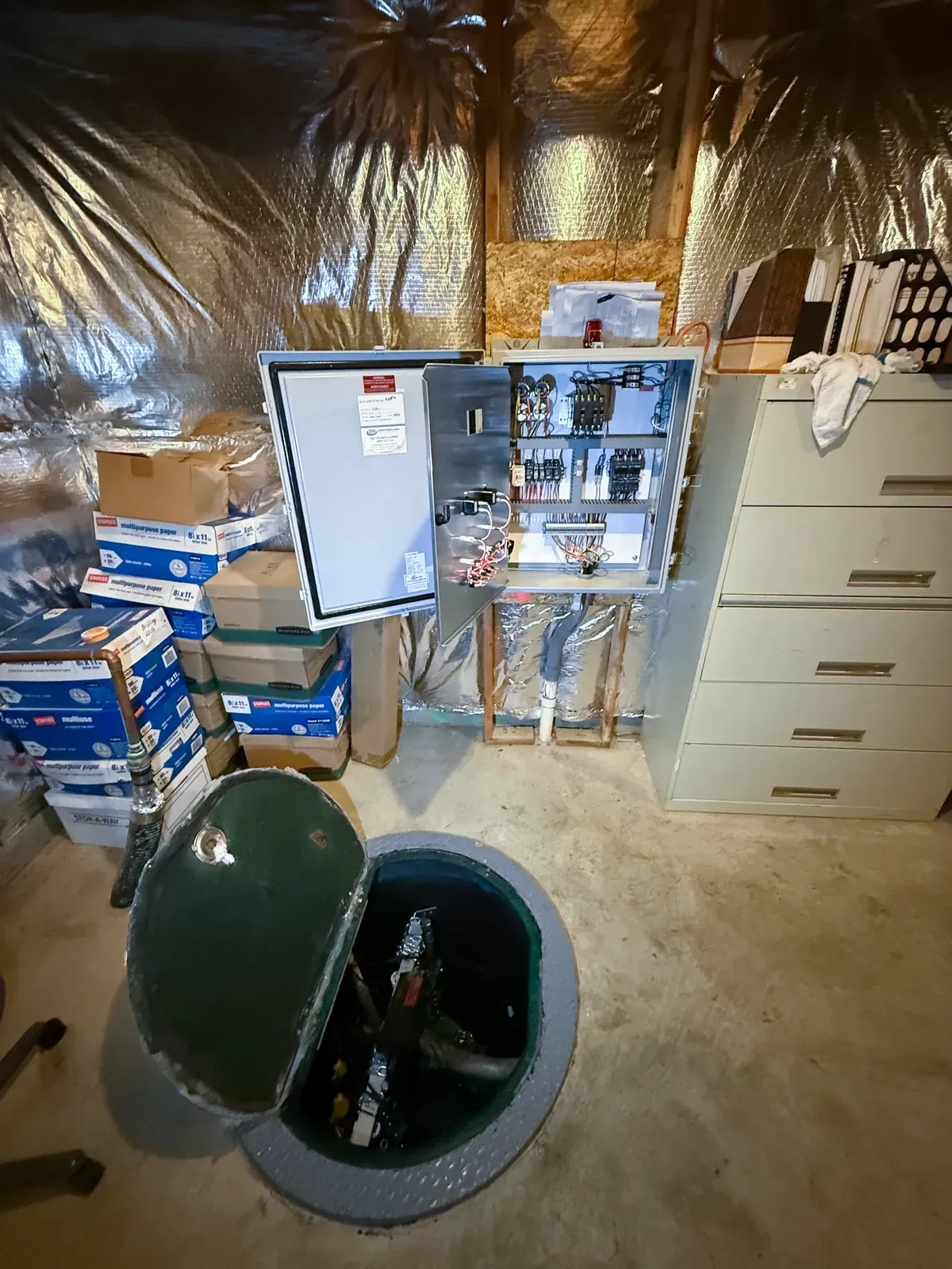Sewage pump basin and control panel at a Mallick Plumbing & Heating job