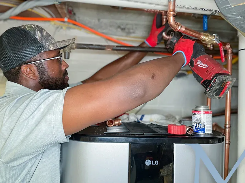 Mallick technician sweating a copper joint overhead