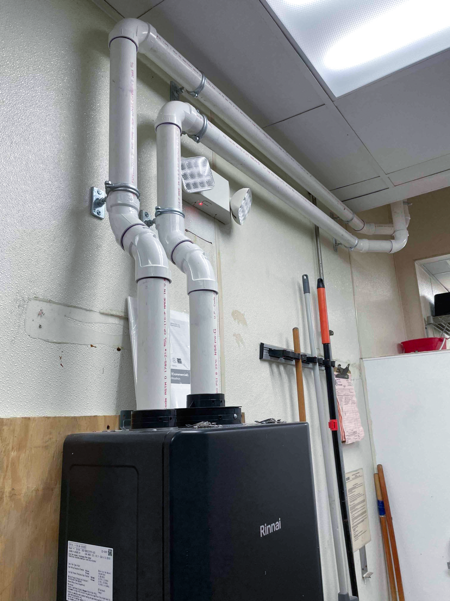 Rinnai commercial tankless water heater PVC venting installation at Gaithersburg restaurant - Mallick Plumbing & Heating