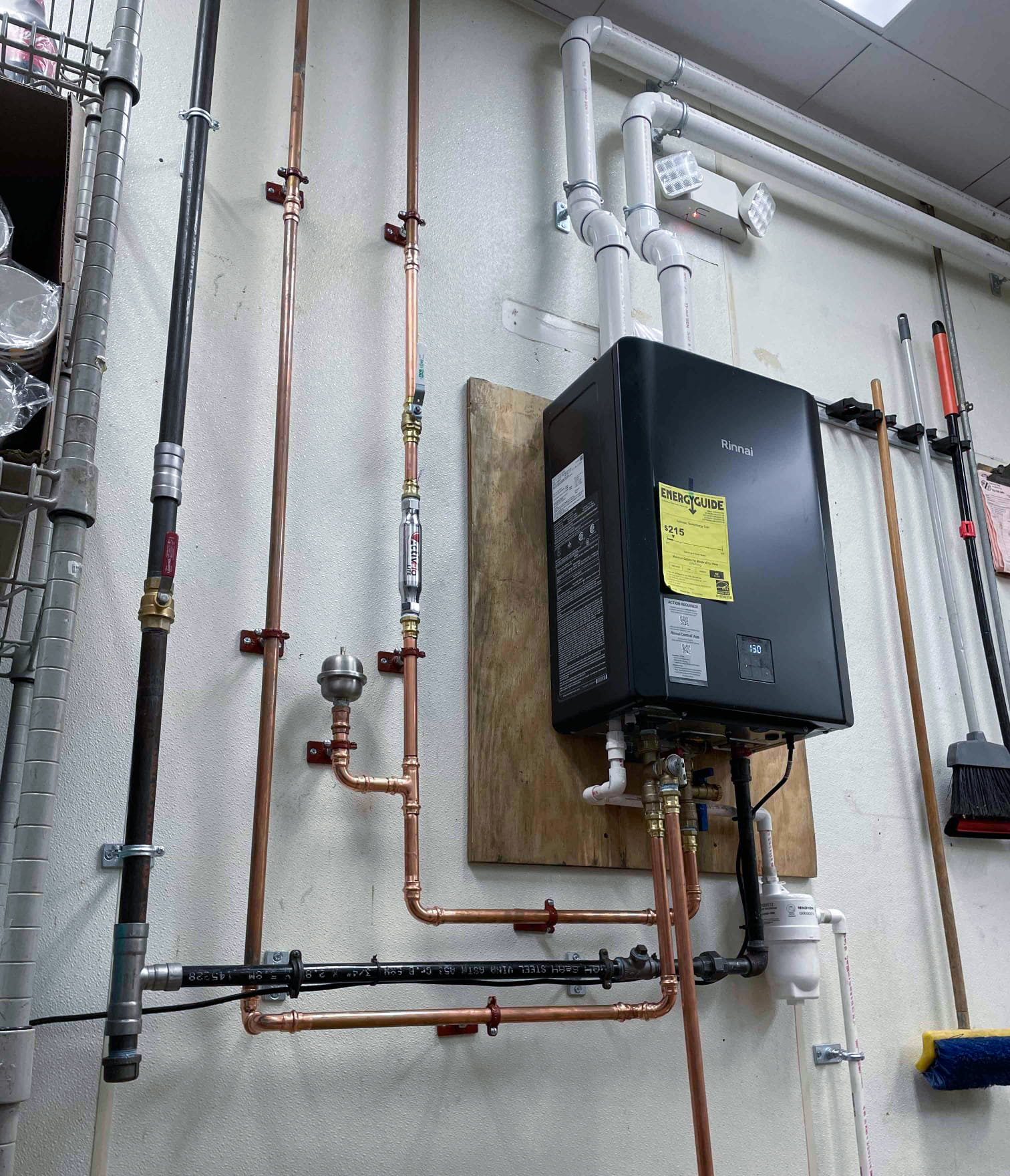 Rinnai commercial tankless water heater wall-mounted with copper piping at Gaithersburg restaurant - Mallick Plumbing & Heating